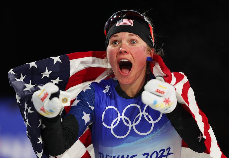 US cross-country skier Jessie Diggins with American flag after winning Bronze medal in 2022 Beijing Olympics