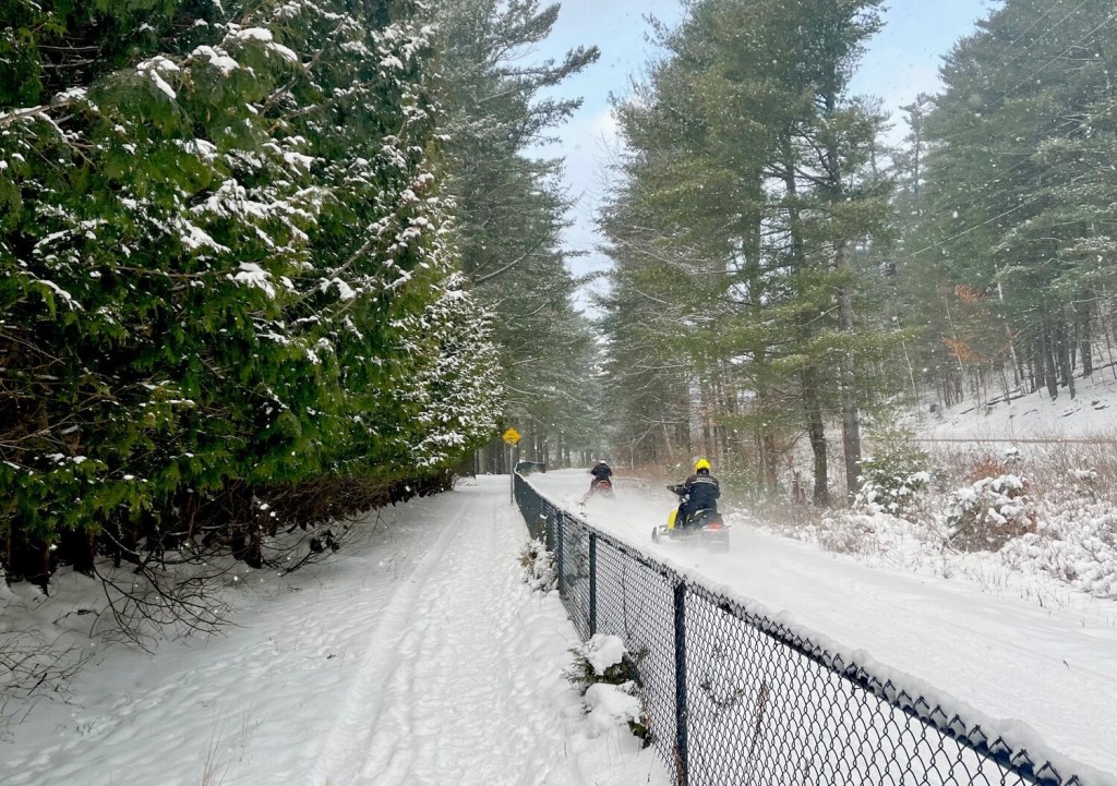 Snow machines on Adirondack Rail Trail in winter.