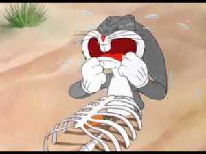 Bugs Bunny partially buried in sand bneath a skeleton on the surface, is in tears because he confuses the skeleton with his body and thinks he's dead.