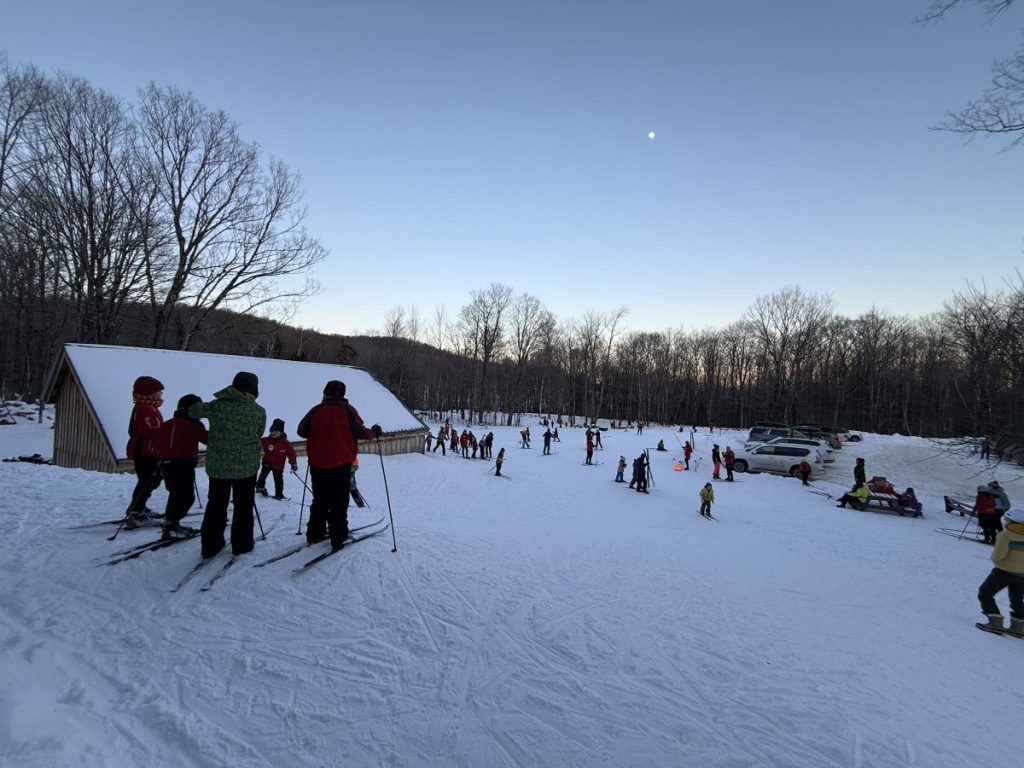 Cross country skiers overlooking Stiles Lane and the Wild Wings ski touring area.