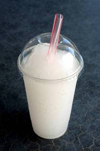 Slushy in a disposable cup with cover and straw